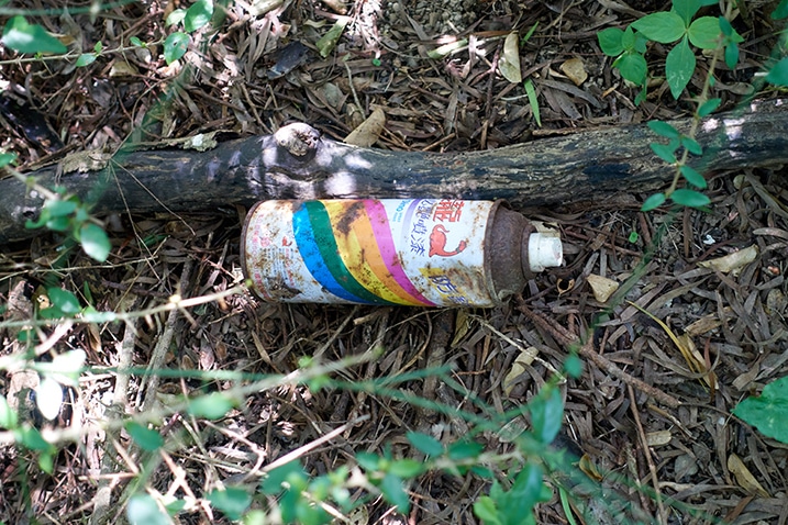 Old discarded can of spray paint on ground