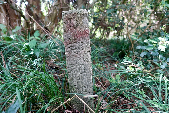 Closeup of very old grave marker stone - tall and square pillar