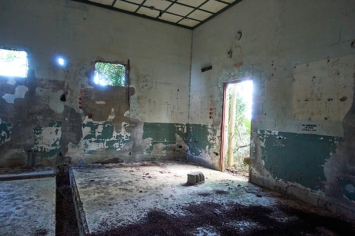 Corner of abandoned room - door to the right - graffiti on walls
