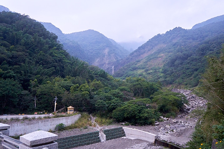 Parking lot with waterfall and mountains beyond