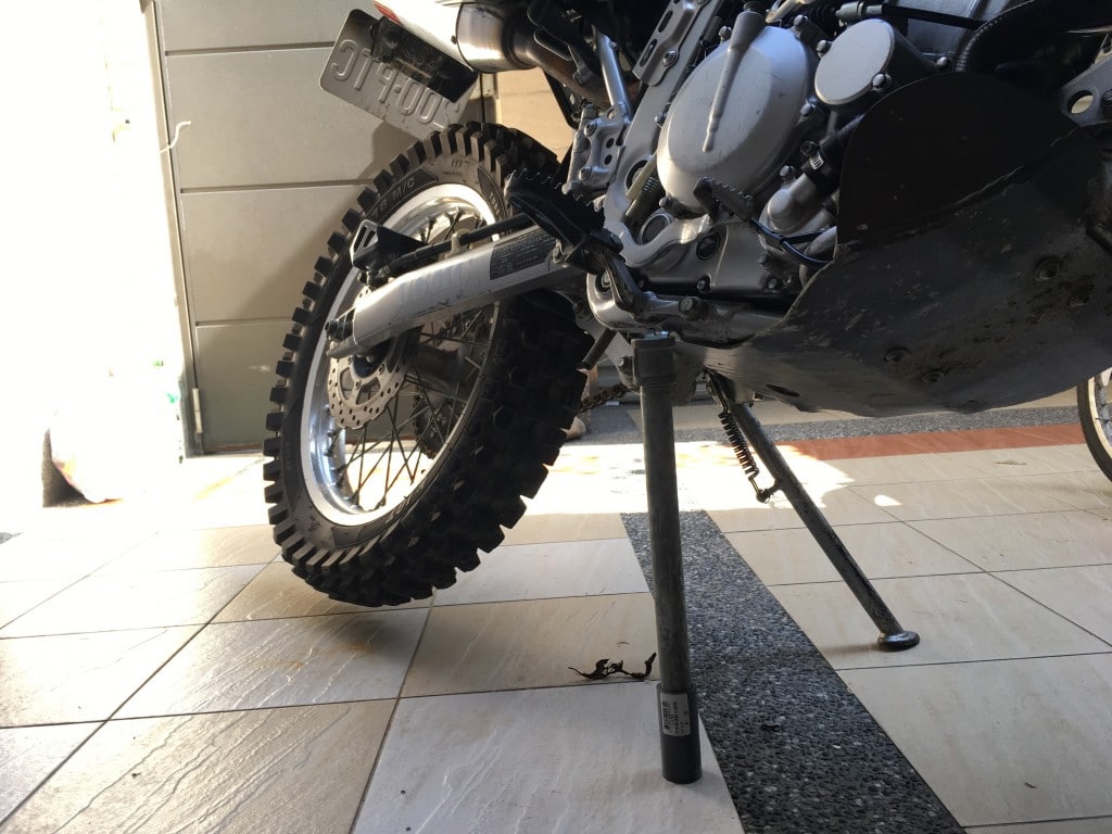 Metal pipe holding up motorcycle