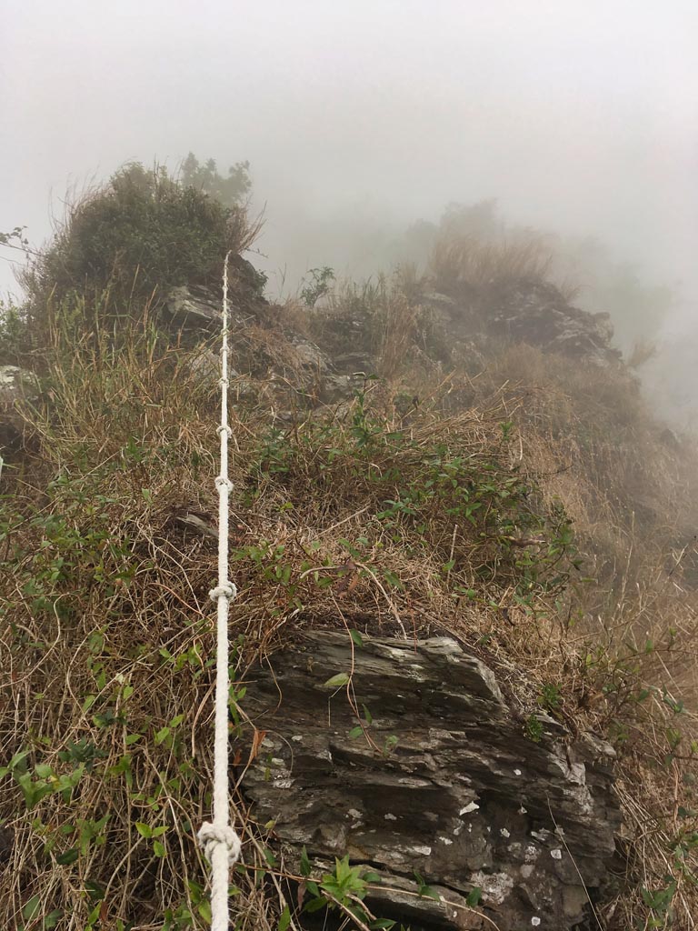 Rocky, foggy ridge with rope