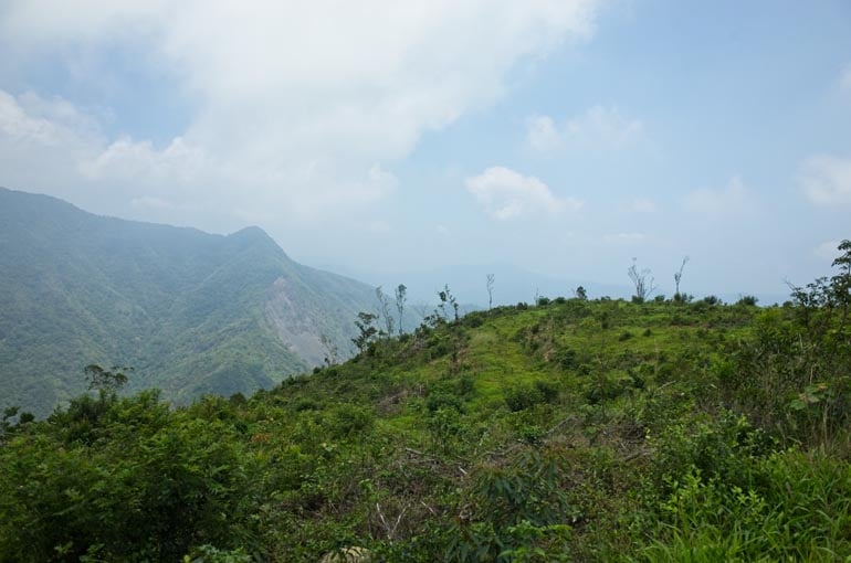 Mountainside with overgrown farmland - cloudy