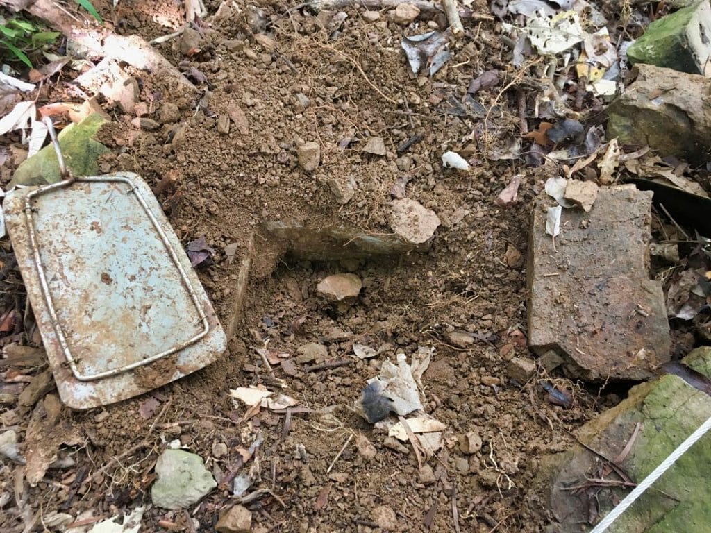 Rectangular hole dug with metal plate on top
