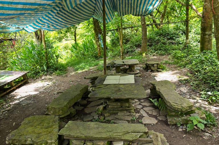 Inside the cleared area - better view of the stacked stone tables and chairs