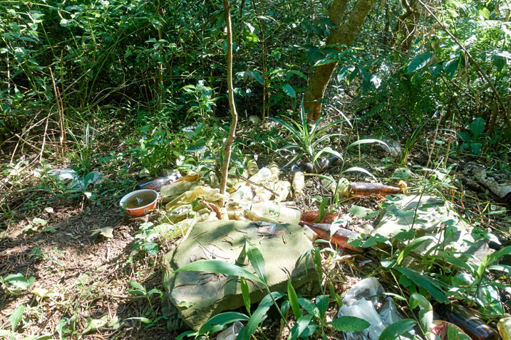 Garbage - plastic bottles - glass bottles - old instant noodle bowls - littered all over the ground