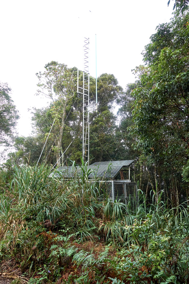 Fenced off area with tall antenna and solar panels