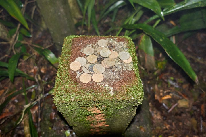 Stone marker with coins on top
