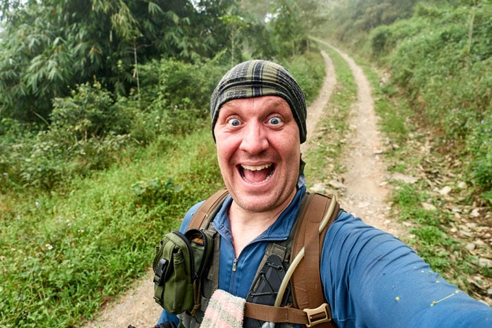 Happy man in the middle of a dirt road