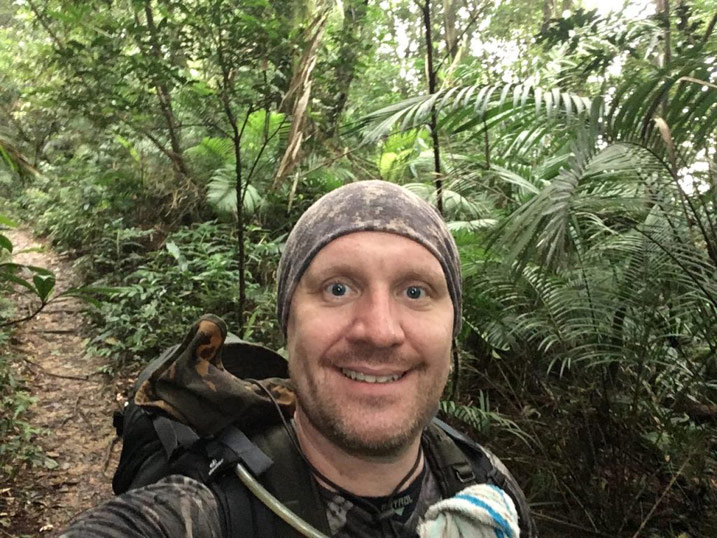Man on trail taking selfie
