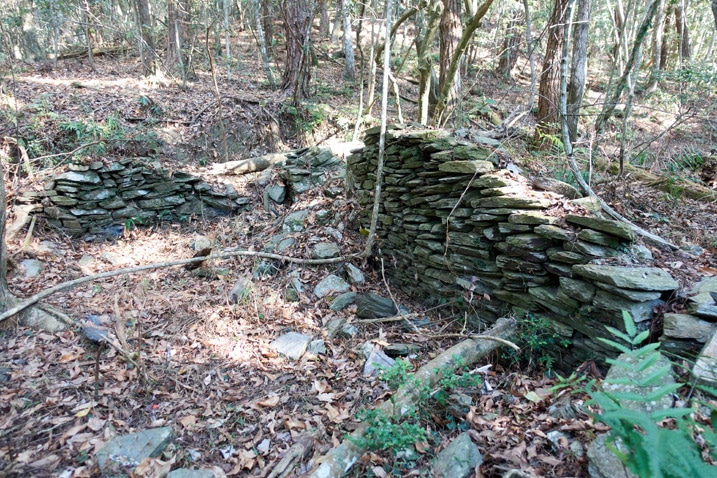 Rocks stacked as a foundation for a traditional style aboriginal structure