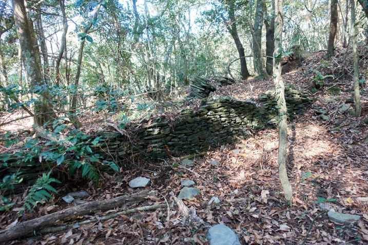 Rocks stacked as a foundation for a traditional style aboriginal structure