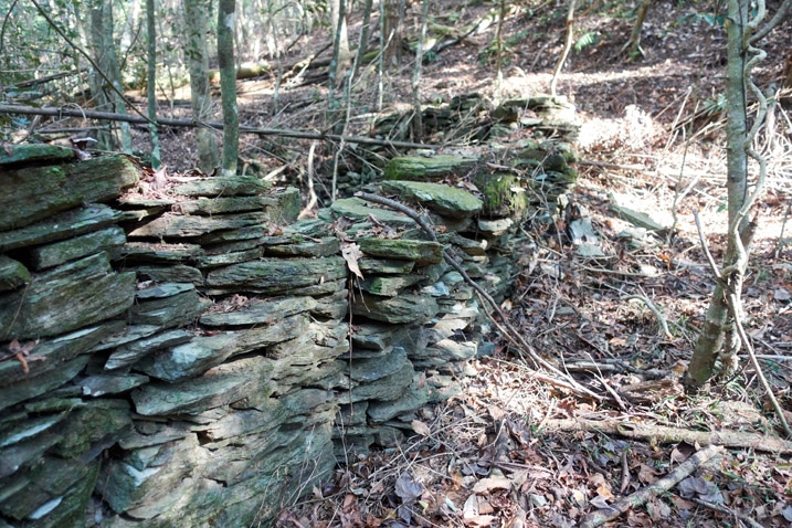 Rocks stacked as a foundation for a traditional style aboriginal structure