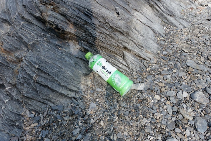 Plastic bottle discarded on riverbed