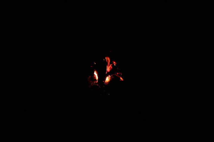 Faint glow of a fire - black all around