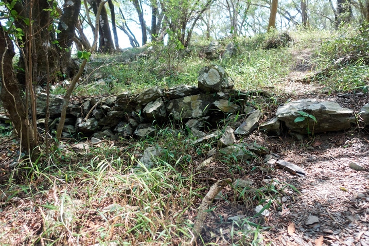 Trail leading up past many stacked stones at a low height