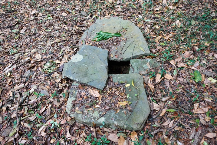 Three flat stones covering hole