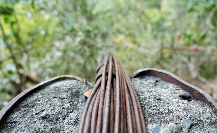 Closeup of footbridge cable over pillar