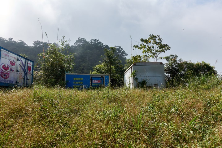 Several delivery truck trailers in an open field