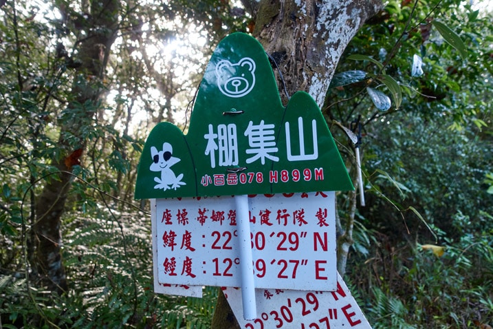 Green sign with handle for PengJiShan 棚集山 - attached to tree