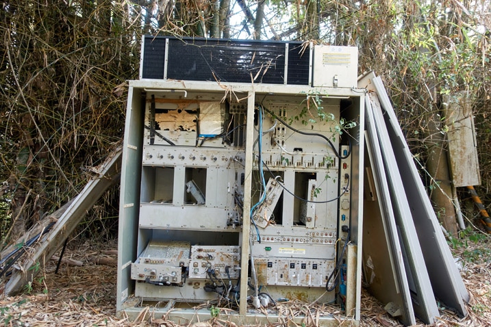 Old computer equipment discarded on mountain ridge